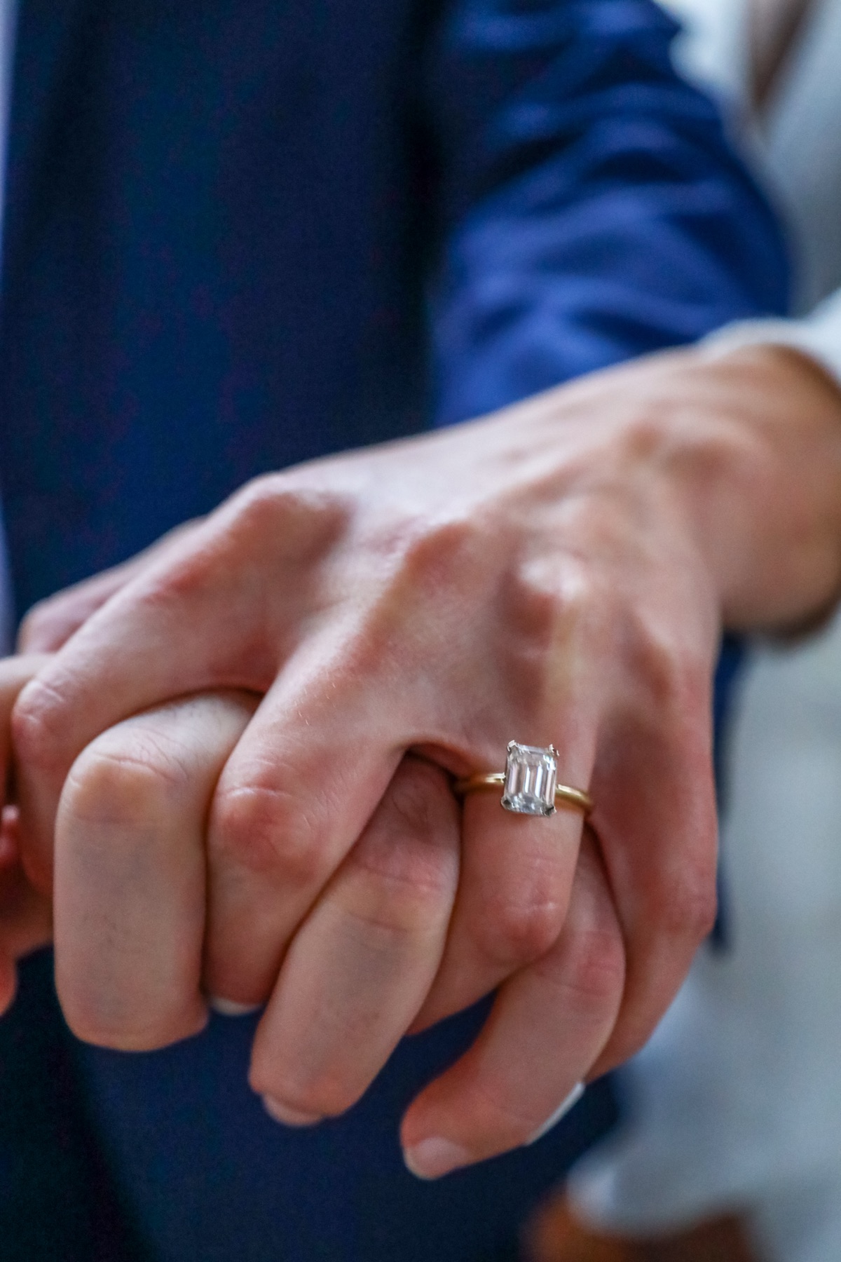 Her hand on his, the new ring catching the light