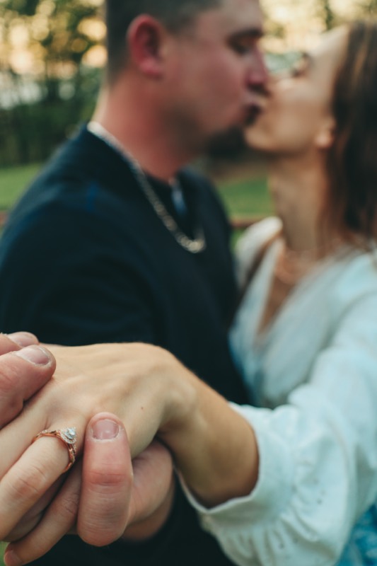 A kiss, her ring hand on his arm