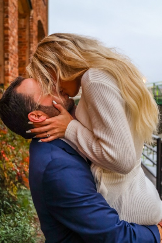 She jumps into his arms by the river